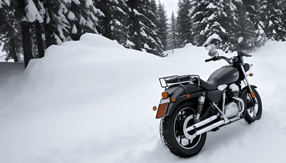 Black motorcycle parked outdoors in deep snow with pine trees and heavy winter scenery