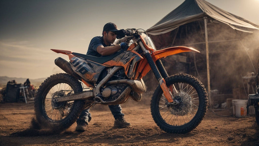 Man adjusting chain on orange off-road dirt bike in a dusty outdoor setting