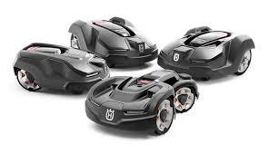 Four black robotic lawn mowers with sleek design on a white background