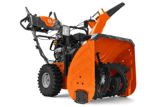 Orange two-stage snow blower with rugged tires and front auger visible against plain background
