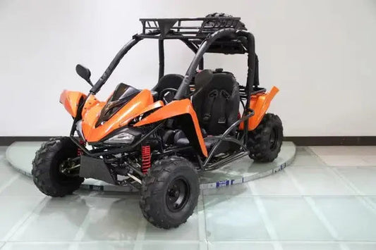Orange two-seater go-kart with roll cage and rugged off-road tires indoors
