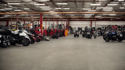Spacious indoor powersports service shop with ATVs, dirt bikes, and motorcycles lined up.