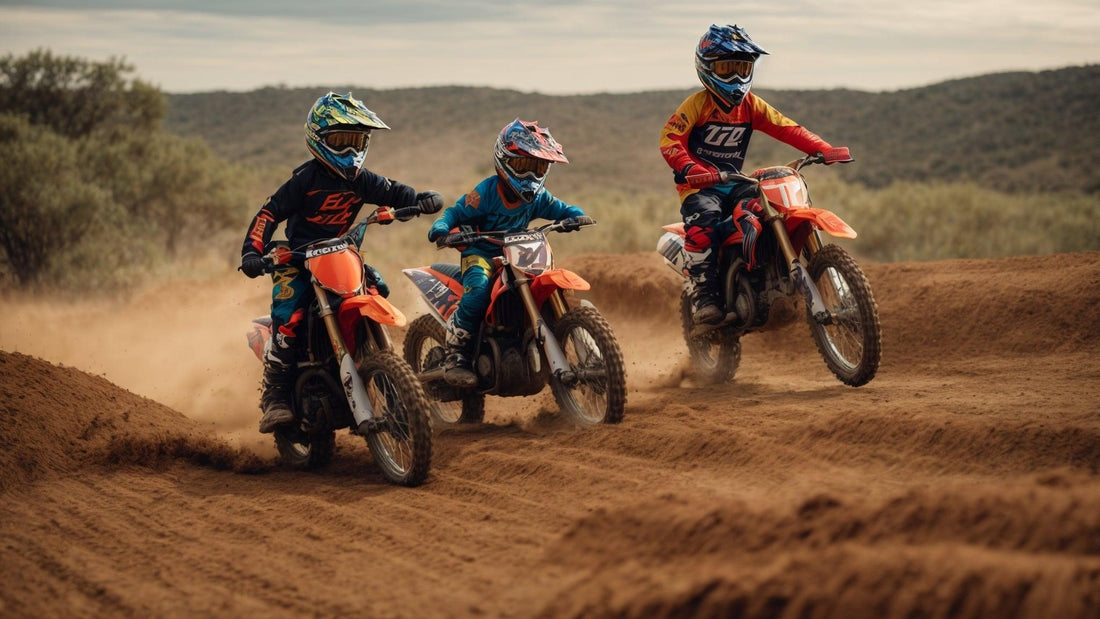 Kids riding gas-powered dirt bikes on an off-road dirt trail outdoors