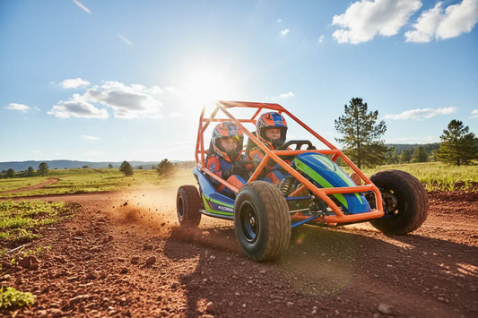 Kids riding off-road go-kart with roll cage on a dirt trail in outdoor countryside.