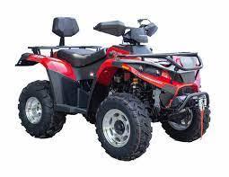 Red all-terrain vehicle ATV with large tires, backrest, and front grill on white background