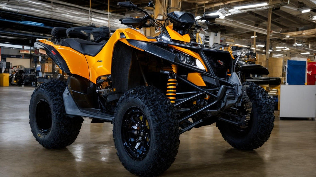 Yellow sport ATV with rugged tires on a factory showroom floor