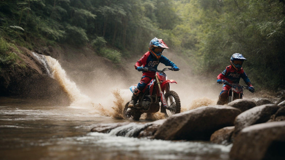 Kids riding dirt bikes across a rocky stream near a waterfall in the forest