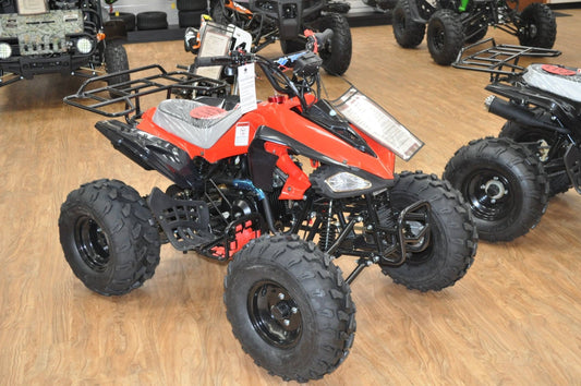 Red and black 125cc youth ATV with large tires and cargo racks in a showroom