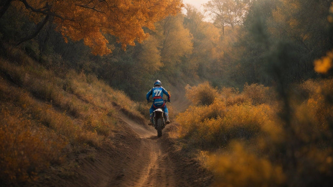 Teen riding 125cc off-road dirt bike on a forest trail in autumn