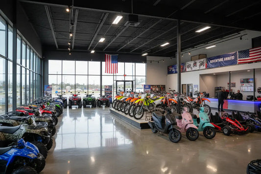 Modern dealership showroom with ATVs, dirt bikes, scooters, and go-karts on display