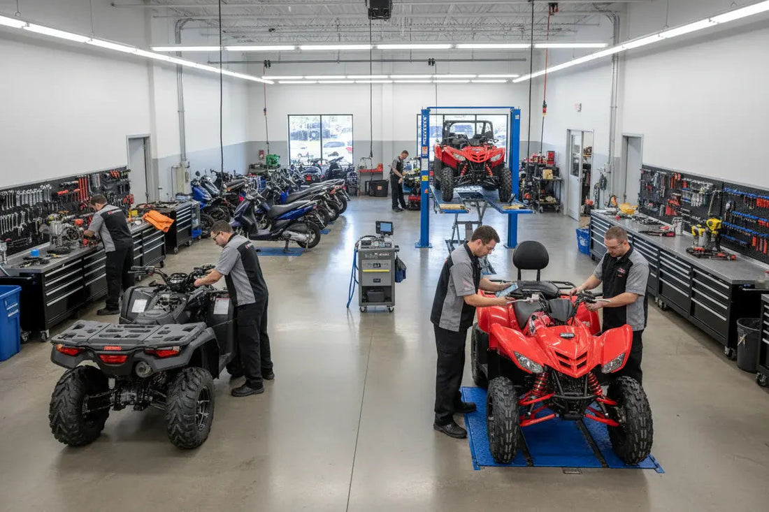 Technicians servicing ATVs and scooters in a clean, organized powersports service center