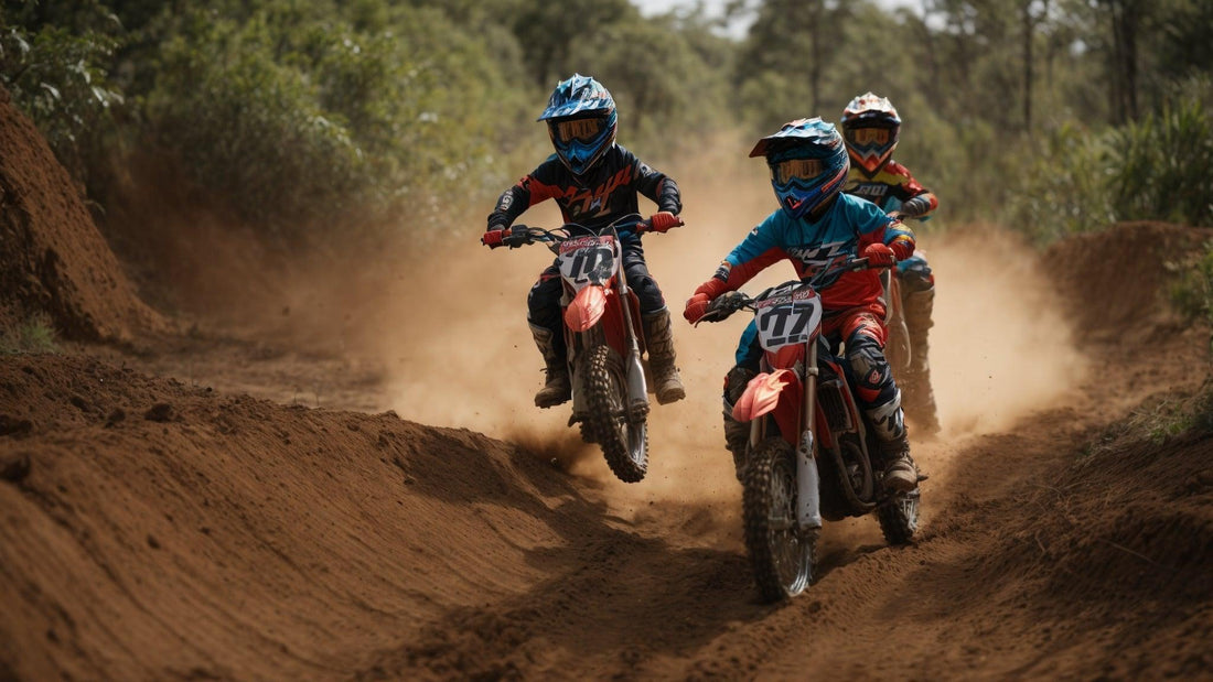 Kids riding youth dirt bikes with helmets and gear on a dusty outdoor trail