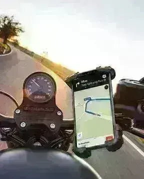 Motorcycle handlebar phone holder with smartphone displaying GPS navigation on a winding road