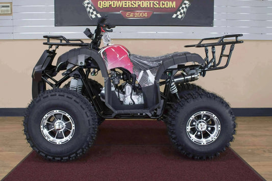 Red and black 125cc utility ATV with rugged off-road tires on showroom floor