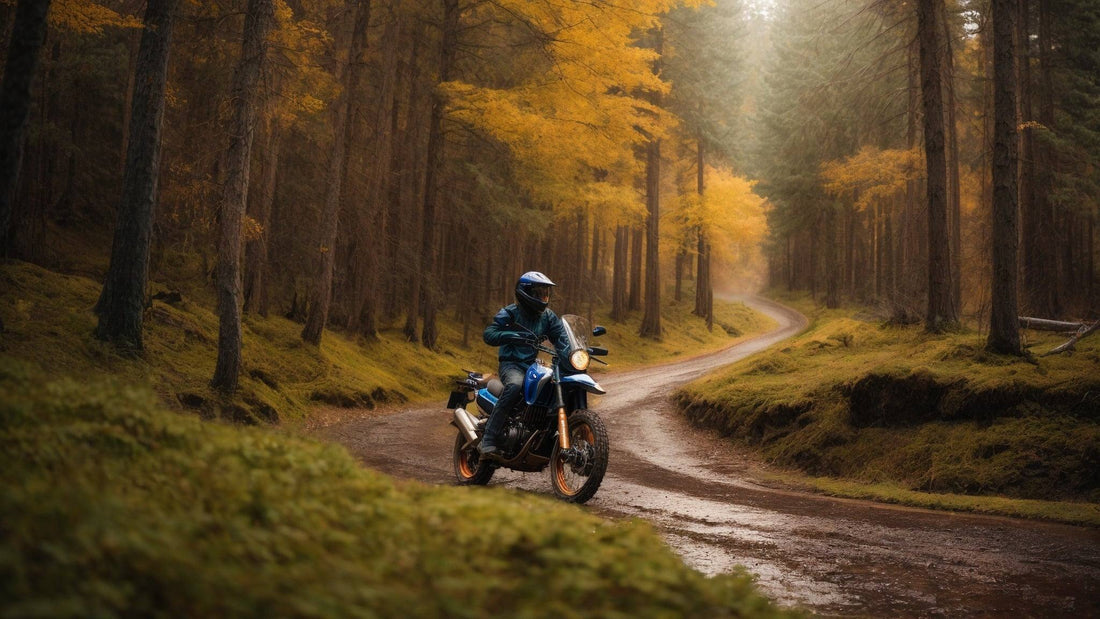 Rider on blue dirt bike navigating a muddy forest trail with autumn trees