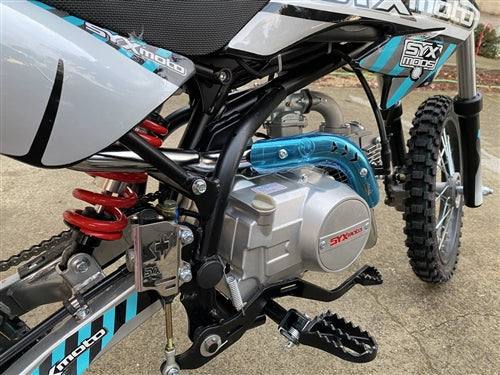 Close-up of 125cc youth dirt bike engine and suspension outdoors