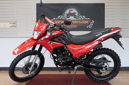 Red RPS Hawk 250 off-road dirt bike with knobby tires and sporty design in showroom