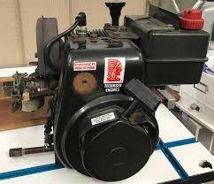 Tecumseh small gas engine on workbench for ATV, go-kart, or scooter repair
