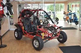 Red 200cc go-kart with two seats displayed indoors on showroom floor