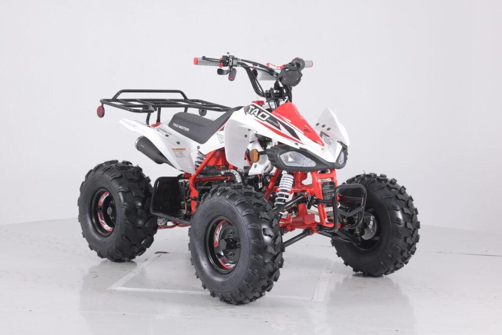Red and white youth ATV with rugged tires, front brush guard, and rear utility rack