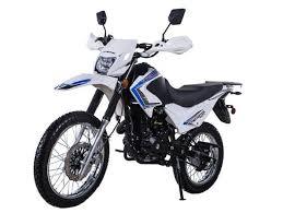 White dual sport 250cc motorcycle with off-road tires and headlight, photographed indoors.