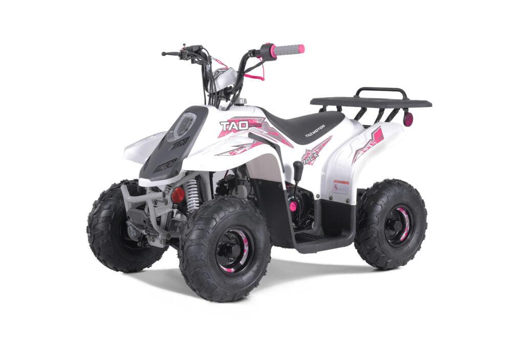 White and pink youth ATV with rugged tires and rear rack on a white background