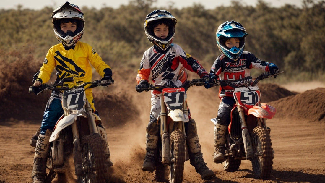 Three kids riding dirt bikes on a dirt track, wearing motocross helmets and racing gear.