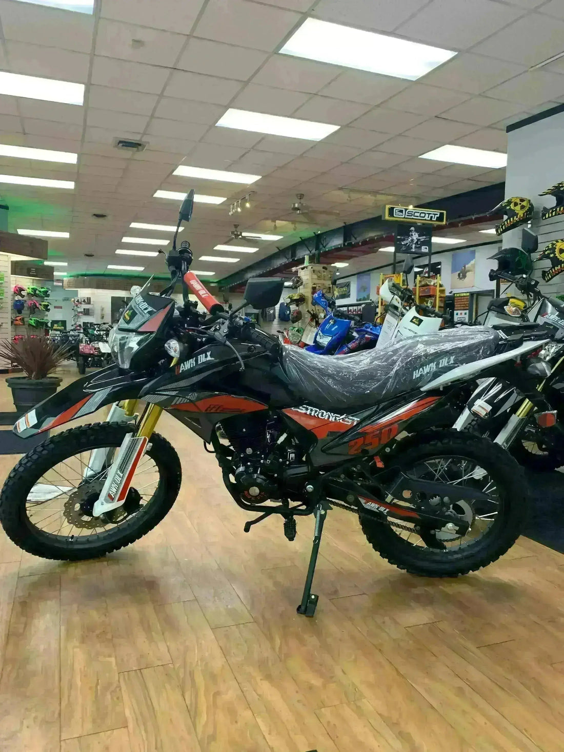 RPS Hawk DLX 250 dual sport motorcycle on showroom floor with off-road tires