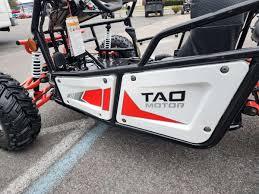 Tao Motor go-kart side panel with rugged tires and frame, parked outdoors