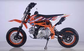Entry-level gas-powered kids dirt bike with orange frame, knobby tires, and bold graphics