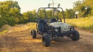Entry-level gas-powered kids go-kart on a dirt trail in a sunny outdoor setting