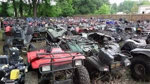 Large outdoor lot filled with various ATVs and quad bikes for sale