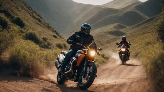 Two riders on 250cc dual sport motorcycles riding on a dirt trail through green hills