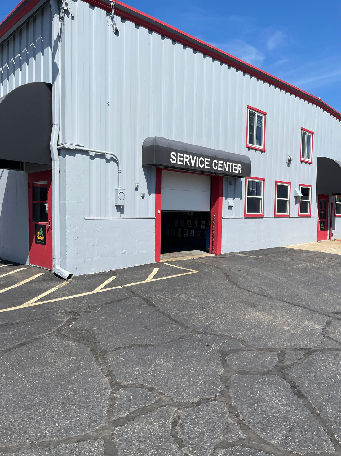 Q9 PowerSports USA ATV repair shop service center exterior in Madison, WI, with open garage door