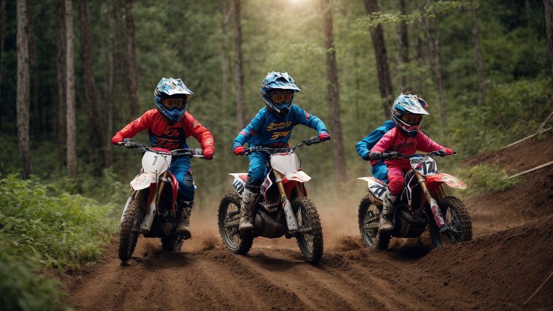Three kids in motocross gear riding youth dirt bikes on a forest trail