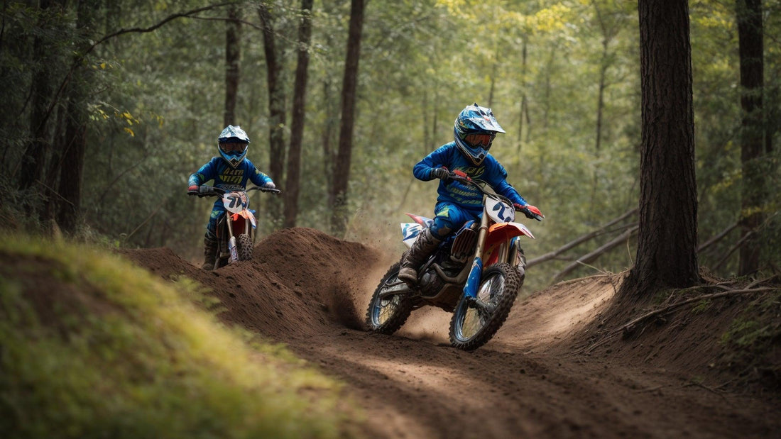 Two kids riding youth dirt bikes on a forest trail, wearing blue motocross gear and helmets