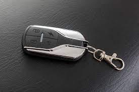 Remote key fob for kids ATV with keychain on a black leather surface