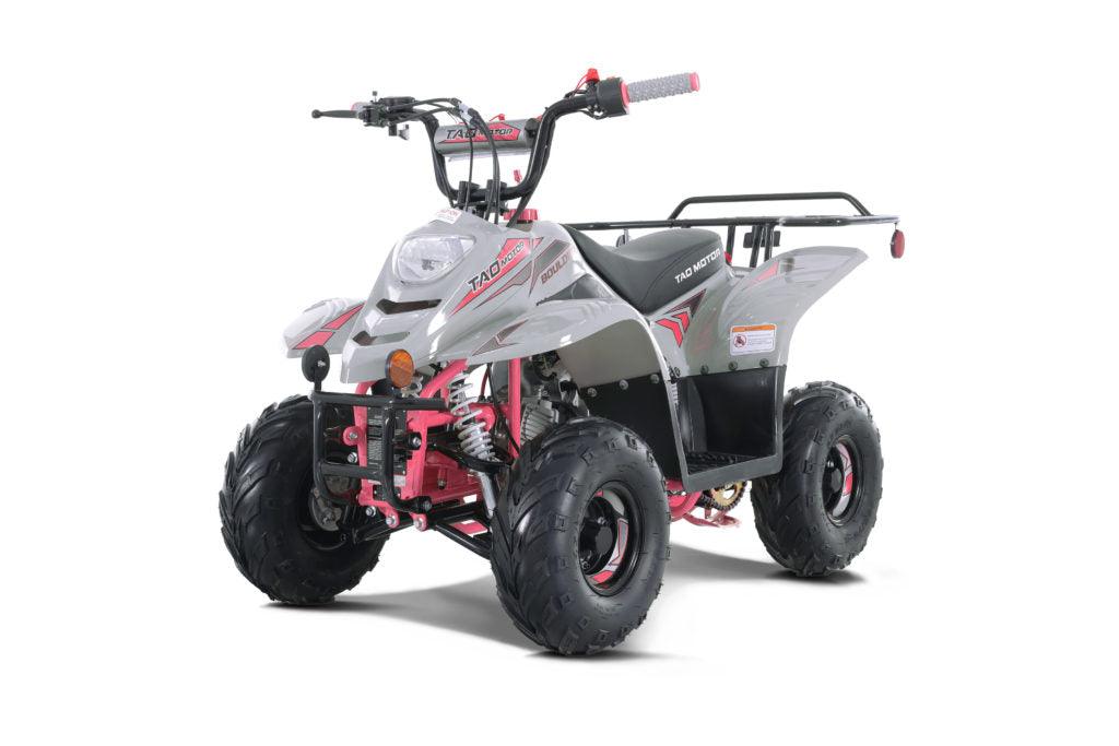 Gray and pink 110cc kids ATV with rugged tires, front headlights, and rear cargo rack