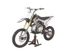 Off-road dirt bike with black and white frame on stand, knobby tires, and gold front forks