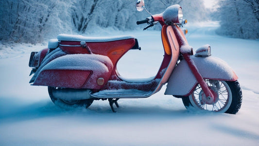 Red scooter covered in snow parked outdoors on a snowy winter road.