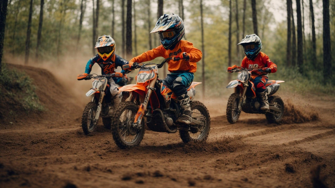 Kids riding dirt bikes on an outdoor dirt trail in full safety gear and helmets