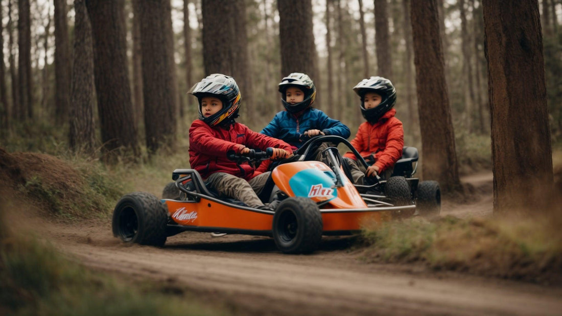 Young kids in helmets riding an orange go-kart on a dirt trail in a forest