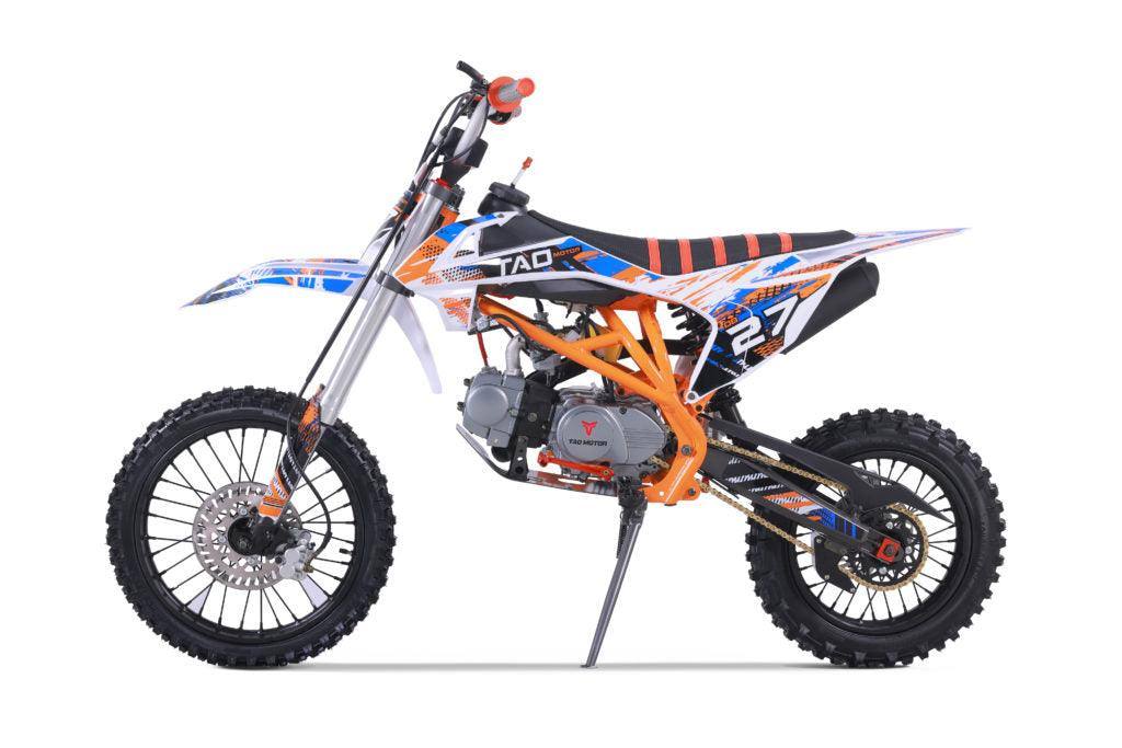 Orange and blue youth dirt bike with off-road tires and number 27 on side view