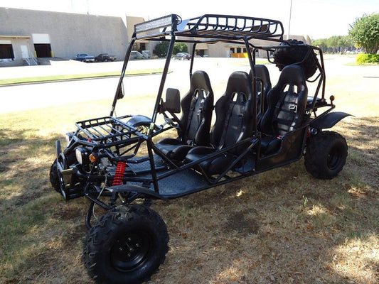 Four-seater off-road go-kart with roll cage and rugged tires parked outdoors