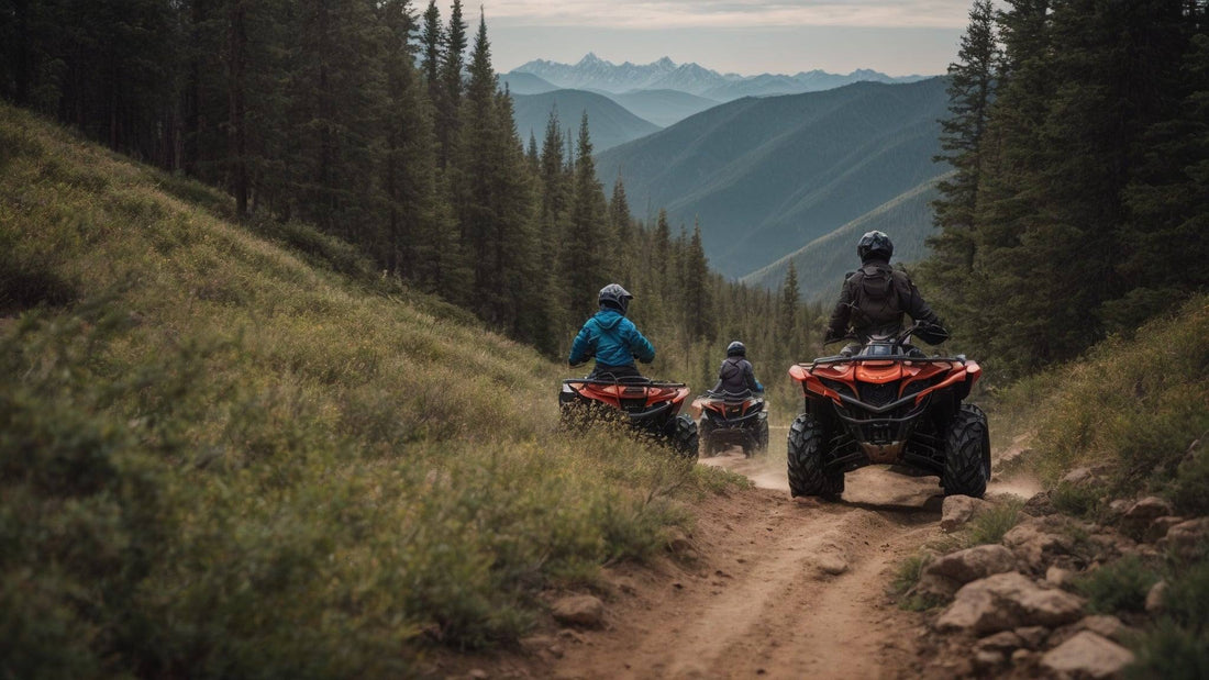 Group riding ATVs on a scenic forest trail with mountains in the background