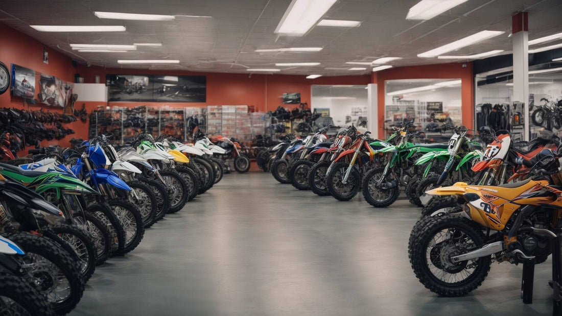 Showroom with rows of off-road dirt bikes and ATVs for sale, brightly lit interior.